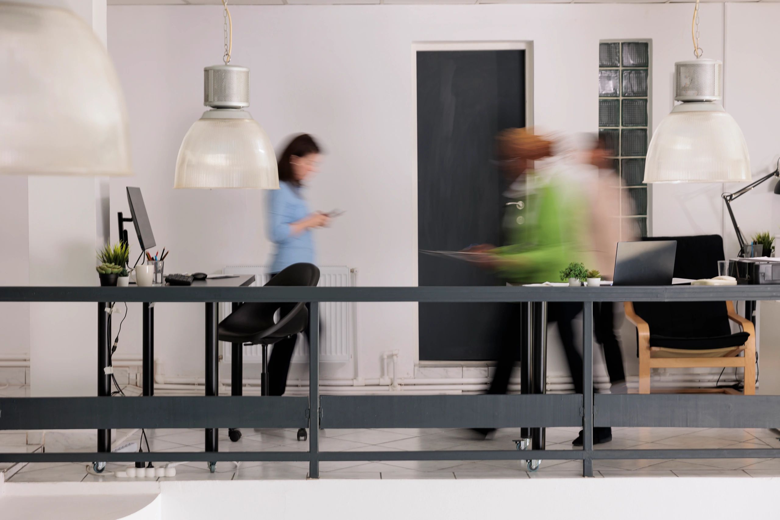 Professionals moving through a busy coworking office