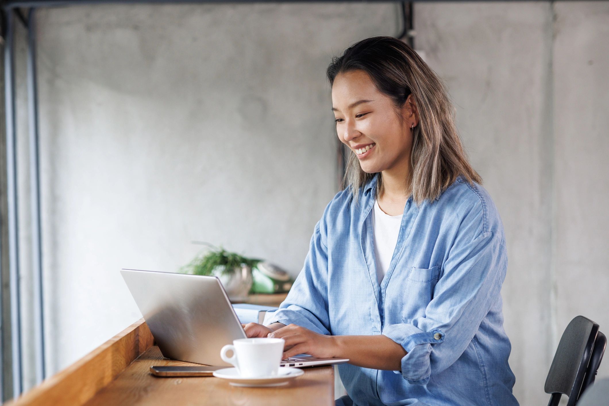Young woman working on a laptop in a coworking space